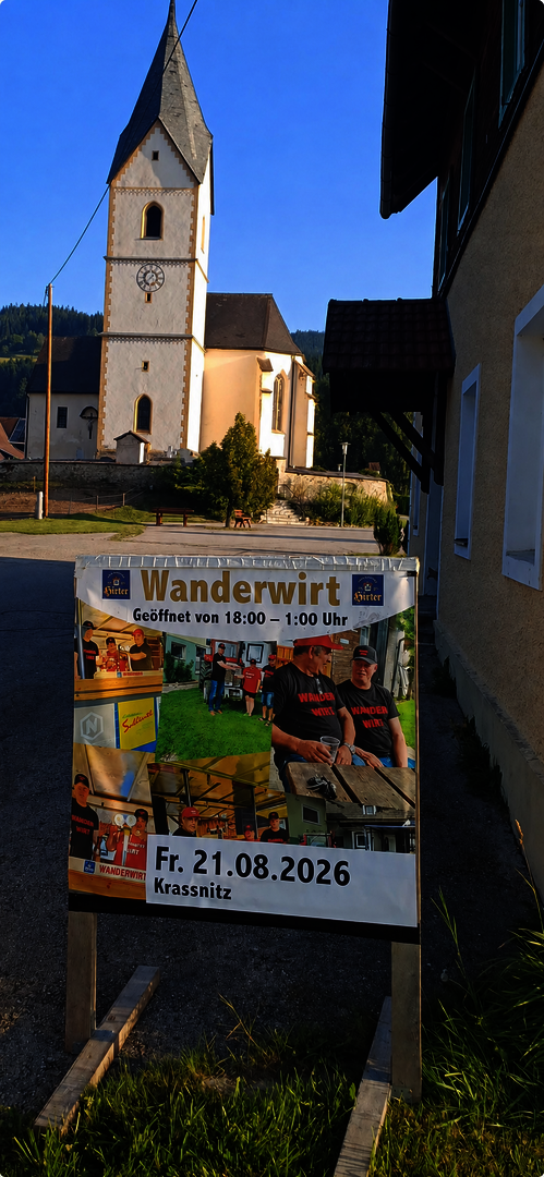 Wanderwirt Krassnitz am 21.08.2026 mit Kirchturm und Ortsschild